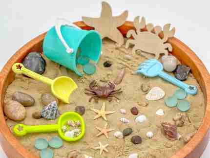 Beach sensory bin with sand and tools
