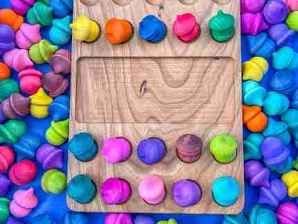 Watercolor dyed wooden acorns for sensory play