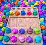 Watercolor dyed wooden acorns for sensory play