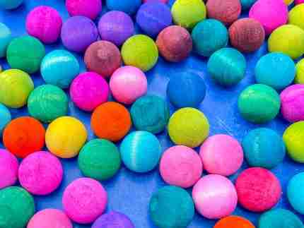 Watercolor dyed wooden acorns for sensory play