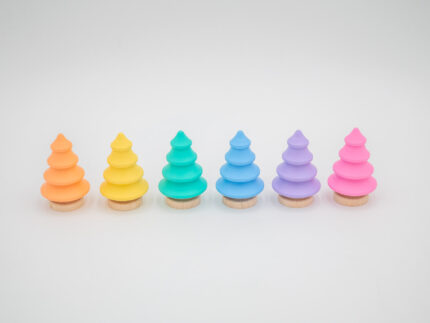 Pastel wooden trees in pink, yellow, peach, mint, blue, and lavender with natural wood bases