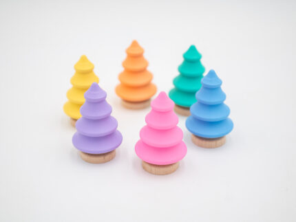 Pastel wooden trees in pink, yellow, peach, mint, blue, and lavender with natural wood bases