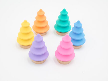 Pastel wooden trees in pink, yellow, peach, mint, blue, and lavender with natural wood bases