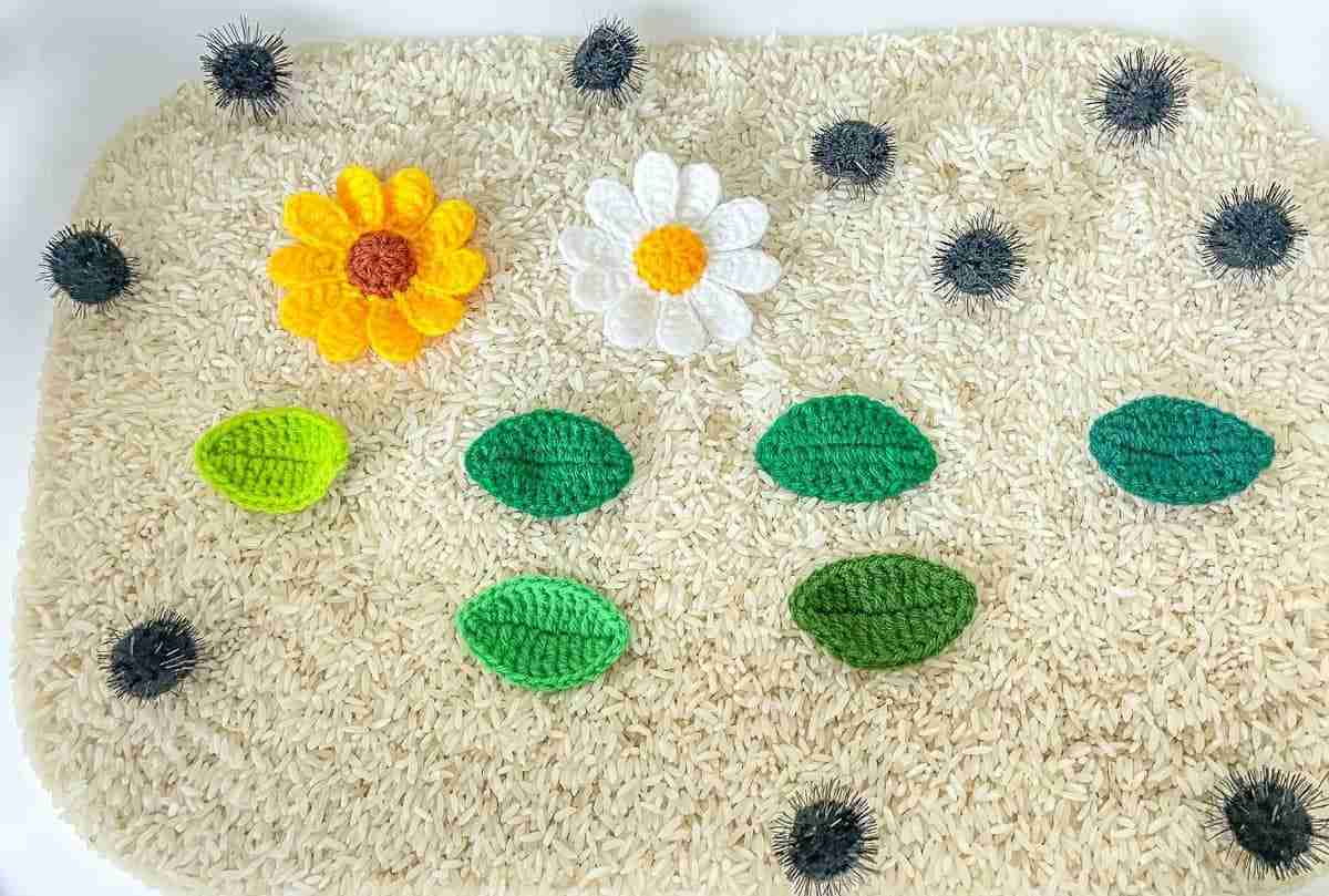 A white carpet with different colored flowers and leaves