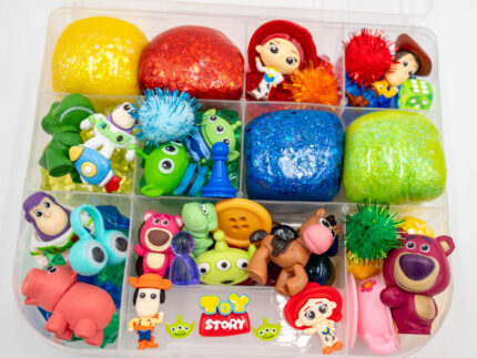 Deluxe Toy Story Play-Doh Kit with colorful glitter dough, character figures, gems, pom-poms, and themed sensory play pieces