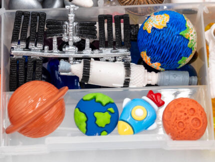 Deluxe Outer Space Play-Doh Kit with colorful dough, astronauts, rockets, planets, spacecraft, and space-themed sensory pieces