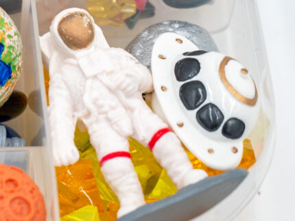 Deluxe Outer Space Play-Doh Kit with colorful dough, astronauts, rockets, planets, spacecraft, and space-themed sensory pieces