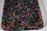 Midnight Rainbow sensory filler with black rice and colorful rainbow couscous
