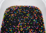 Midnight Rainbow sensory filler with black rice and colorful rainbow couscous