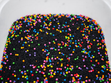 Midnight Rainbow sensory filler with black rice and colorful rainbow couscous