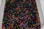 Midnight Rainbow sensory filler with black rice and colorful rainbow couscous
