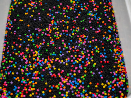 Midnight Rainbow sensory filler with black rice and colorful rainbow couscous
