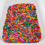 Rainbow Explosion Sensory Filler Mix with colorful rice pasta chickpeas and pearls