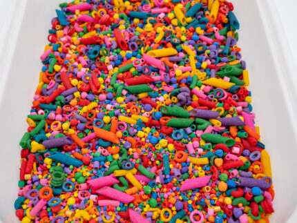 Rainbow Explosion Sensory Filler Mix with colorful rice pasta chickpeas and pearls