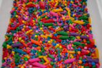 Rainbow Explosion Sensory Filler Mix with colorful rice pasta chickpeas and pearls