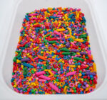 Rainbow Explosion Sensory Filler Mix with colorful rice pasta chickpeas and pearls