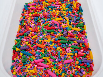 Rainbow Explosion Sensory Filler Mix with colorful rice pasta chickpeas and pearls