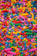 Rainbow Explosion Sensory Filler Mix with colorful rice pasta chickpeas and pearls