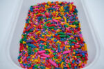 Rainbow Explosion Sensory Filler Mix with colorful rice pasta chickpeas and pearls