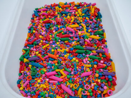 Rainbow Explosion Sensory Filler Mix with colorful rice pasta chickpeas and pearls