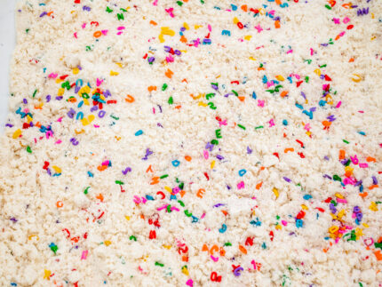Alphabet Cloud Dough with colorful letter pieces for sensory play