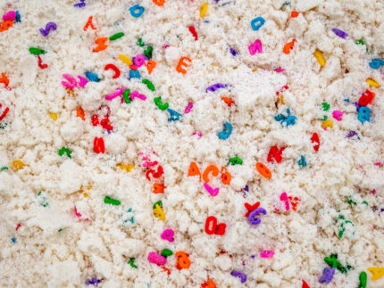 Alphabet Cloud Dough with colorful letter pieces for sensory play