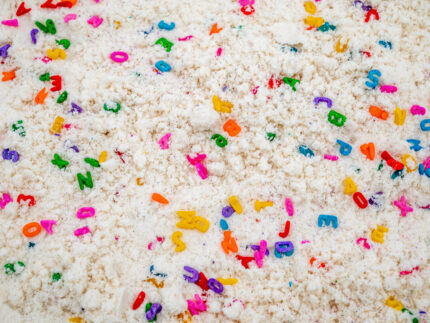 Alphabet Cloud Dough with colorful letter pieces for sensory play