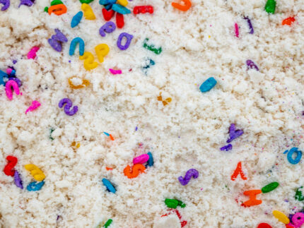 Alphabet Cloud Dough with colorful letter pieces for sensory play