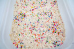 Alphabet Cloud Dough with colorful letter pieces for sensory play