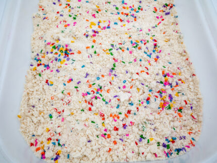 Alphabet Cloud Dough with colorful letter pieces for sensory play