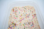 Alphabet Cloud Dough with colorful letter pieces for sensory play