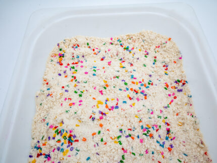 Alphabet Cloud Dough with colorful letter pieces for sensory play