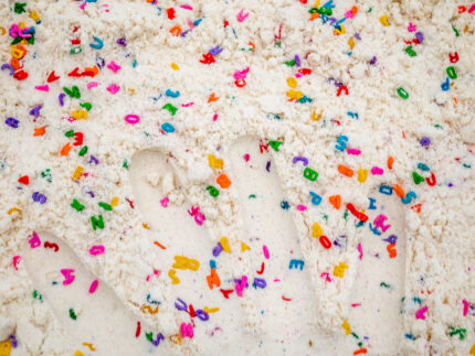 Alphabet Cloud Dough with colorful letter pieces for sensory play