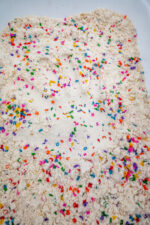 Alphabet Cloud Dough with colorful letter pieces for sensory play
