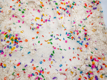 Alphabet Cloud Dough with colorful letter pieces for sensory play