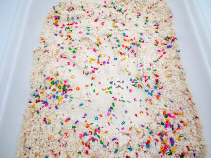 Alphabet Cloud Dough with colorful letter pieces for sensory play