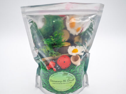 Ladybug Budget Bag with green grass rice wooden ladybugs logs and garden accessories