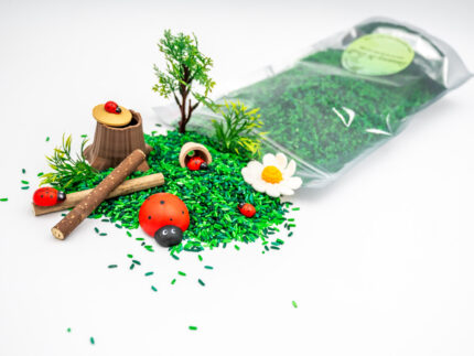 Ladybug Budget Bag with green grass rice wooden ladybugs logs and garden accessories