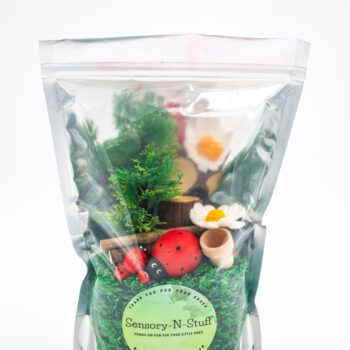 Ladybug Budget Bag with green grass rice wooden ladybugs logs and garden accessories