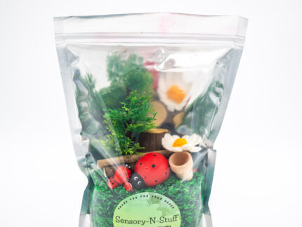 Ladybug Budget Bag with green grass rice wooden ladybugs logs and garden accessories