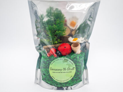 Ladybug Budget Bag with green grass rice wooden ladybugs logs and garden accessories