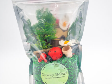 Ladybug Budget Bag with green grass rice wooden ladybugs logs and garden accessories