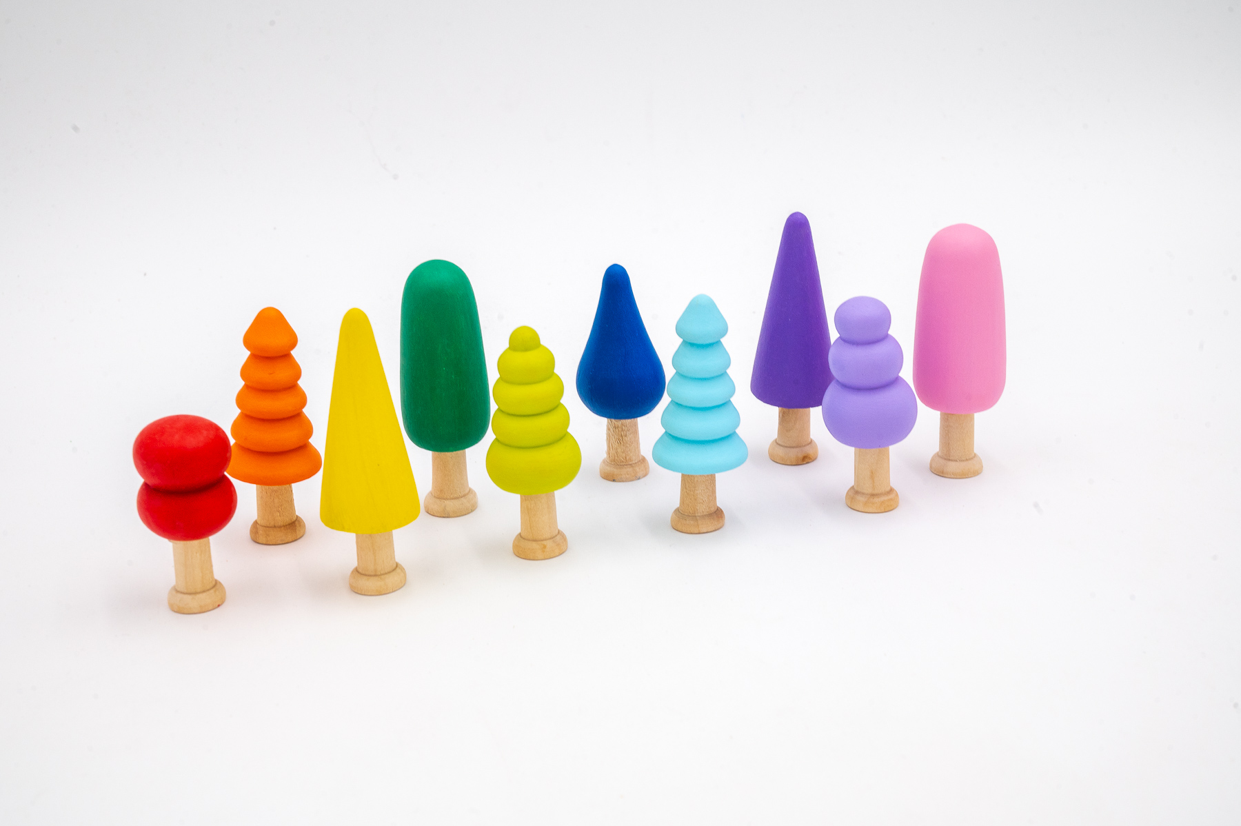Assorted Rainbow Trees Set of 10-7 Assorted Rainbow Wooden Trees set of 10 hand-painted small wooden trees in bright colors and mixed shapes for sensory and small-world play