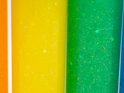 Six glitter calming bottles in pink, orange, yellow, green, blue, and purple with sparkly glitter