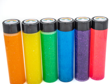 Six glitter calming bottles in pink, orange, yellow, green, blue, and purple with sparkly glitter