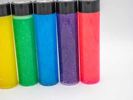 Six glitter calming bottles in pink, orange, yellow, green, blue, and purple with sparkly glitter