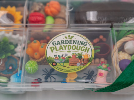 Deluxe Gardening Play-Doh Kit with colorful dough and miniature vegetables, flowers, plants, garden accessories, basket, and nature-themed pieces