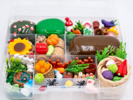 Deluxe Gardening Play-Doh Kit with colorful dough and miniature vegetables, flowers, plants, garden accessories, basket, and nature-themed pieces