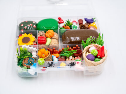 Deluxe Gardening Play-Doh Kit with colorful dough and miniature vegetables, flowers, plants, garden accessories, basket, and nature-themed pieces