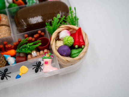 Deluxe Gardening Play-Doh Kit with colorful dough and miniature vegetables, flowers, plants, garden accessories, basket, and nature-themed pieces
